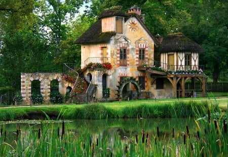 A mill - pretty, calm, summer, grass, forest, reflection, flowers, red, water mill, lake, nice, place, greenery, trees, water, beautiful, mill, pond, lovely, colorful, nature, tranquility, green, delight, serenity, country, peaceful