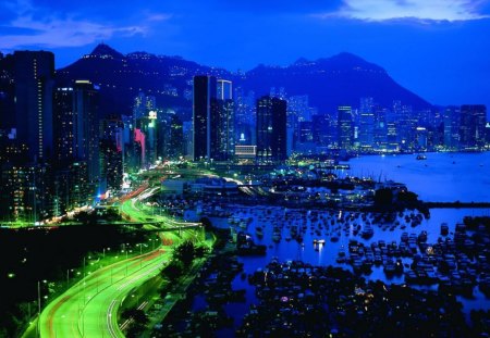 'At Night in Hong Kong' - roads, mountains, other, modern, cool, blue dreams, ferryboats, architecture, bridges, boats, mountain, islands, cars, night, hong kong, light color, skyscrapers, scenery, twilight, streets, colors