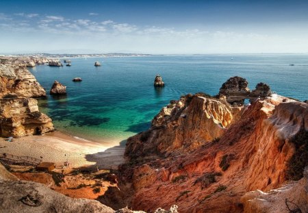 Small Beach Along the Coast - ocean, beach, sky, daylight, cliff, day, water, nature, brown, clouds, tan, blue, rock, sand