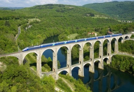 super train on and ancient bridge in france - train, river, hills, bridge, tree, trees, grass