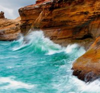 azure waves battering rocky coast