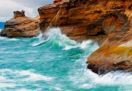 azure waves battering rocky coast