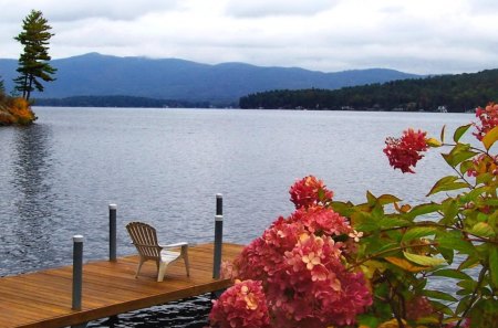 View of a river - relax, summer, horizons, reflection, walk, mountain, calmness, flowers, riverbank, bench, nice, sky, clouds, water, beautiful, lovely, dock, rest, pier, chair, river, wooden, nature