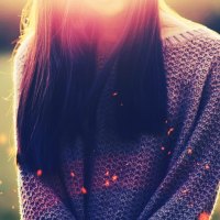 girl with a knitted sweater in a field