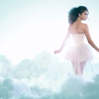 girl in a white dress in the clouds