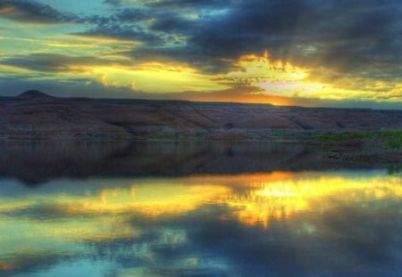 Sunset over the Lake - clouds, water, yellow, blue, rock, colors, reflection, daylight, mountain, sunset, nature, land, lake, day, sun, sky