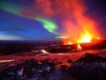 northern lights over an erupting volcano