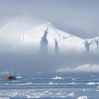 small boat between the ice