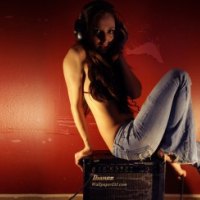 sexy girl with headphones sitting on a speaker