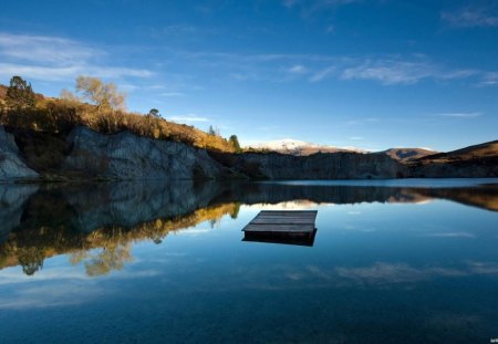 pontoon on a quiet mirrored lake - cliff, lake, reflection, pontoon