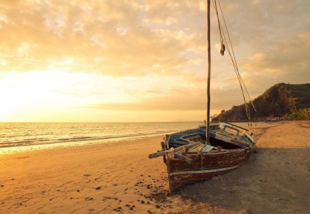 old sailboat on a beautiful beach at sunset - hill, clouds, sunset, beach, boat