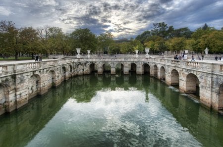 Roman Baths In Nimes - water, baths, beautiful, roman baths, france, sky, architecture, pont du gard, clouds, nimes, roman, trees, colorful