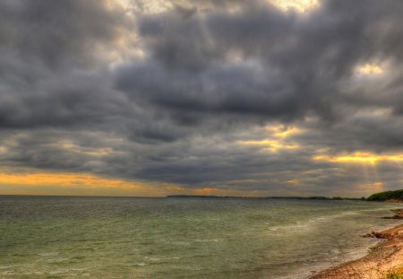 beautiful beach in zealand demark - clouds, sea, sun rays, beach