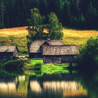 houses are reflected in the lake