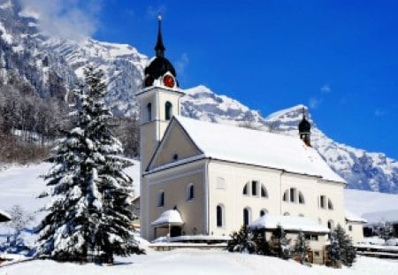 Mountain church - nice, slope, sky, trees, clock tower, countryside, tower, white, pretty, clock, clock rower, mountain, winter, lovely, nature, church, snow, blue, beautiful