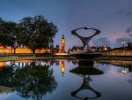 clock tower in london reflected in fountain