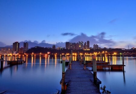 City Lights - splendor, sunrise, city lights, reflection, view, sky, clouds, beautiful, sea, city, beauty, lovely, architecture, ocean, buildings, pier, nature, lights, peaceful, building