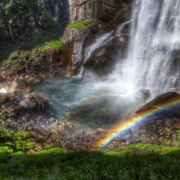 beautiful rainbow at the bottom of a waterfall hdr