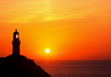 lighthouse at a magnificent sunset - cliff, sea, sunset, lighthouse