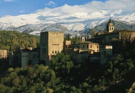 alhambra palace in granada spain - mountains, forest, clouds, palace