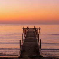 sunrise on pier in jersie beach denmark