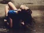 brunette girl laying on wet floor