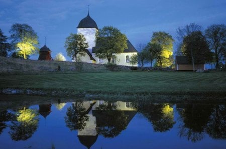 beautiful country church in sweden - trees, church, dusk, pond, lights