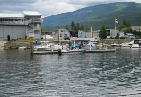 The Marina Gas Station in BC - Canada - lakes, mountains, flags, gas station, shore, white, clouds, photography, boats, marina