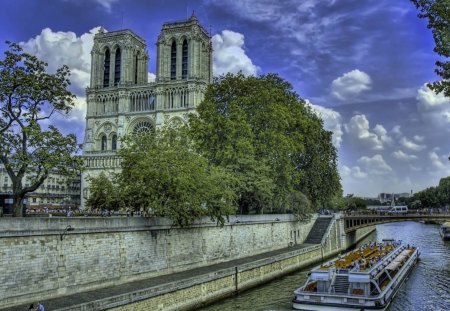 ~Notre Dame de Paris~ - famous, ancient, sky, building, landscape, trees, paris, holy, church, clouds, river, notre dame, boat