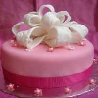 White Bow Topped Pink Cake