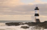 lighthouse on a rough shore in wales