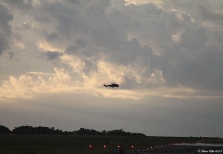 Helichopter coming into land. - airstrip, lights, clouds, helichopter