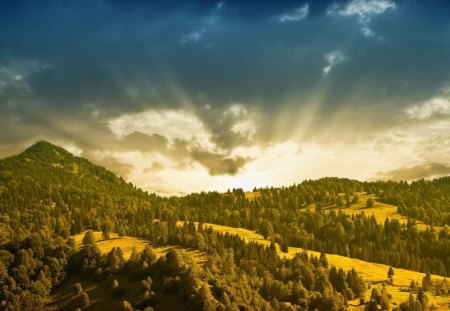 sun rays over lovely landscape - hills, trees, rays, clouds