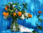 Vase with flowers in blue background