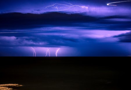 lightning over a black sea - lightning, black, clouds, sea, shore