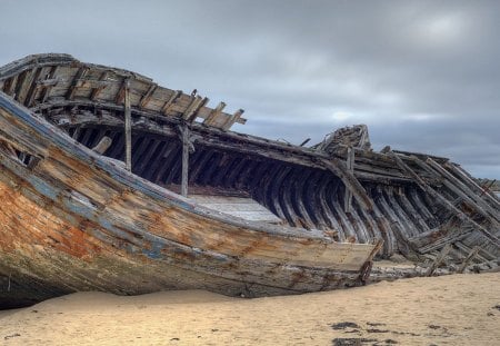 ship skeleton on the beach - beach, skeleton, boat, clouds