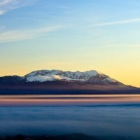 clouds on a valley by a mighty mountain