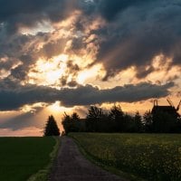 stormy clouds over sunset above windmill