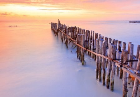 pylons on a caribbean beach at sunset - beach, sunset, sea, pylons