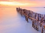 pylons on a caribbean beach at sunset