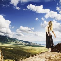 Girl stands on a hill