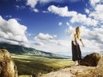 Girl stands on a hill