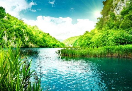 River near the mountain - nice, sky, riverbank, peaceful, greenery, calm, quiet, reflection, pretty, river, clouds, emerald, green, grass, lake, lovely, serenity, nature, blue, beautiful