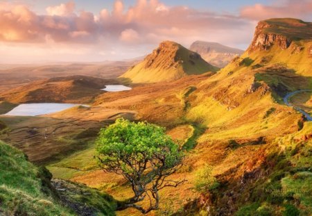 beautiful landscape on the isle of skye - lakes, road, clouds, hills, trees