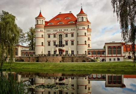 lovely wojnowice castle in poland - pond, castle, towers, trees