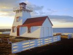 lighthouse with a white picket fence