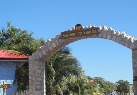 Labadee resort - sign, red, palms, blue, sky, photography, fields, trees, green