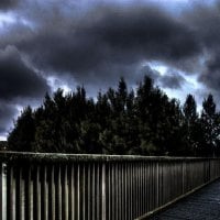 pedestrian bridge under stormy skies hdr