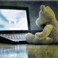 Computer and teddy bear