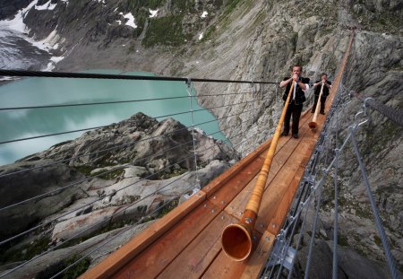 stupendous pedestrian bridge in switzerland - players, cliffs, lake, bridge, horns